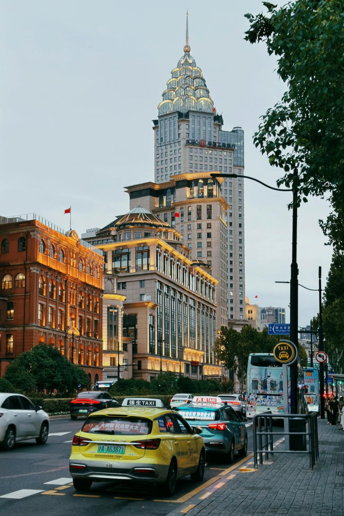 A Shanghai licensed taxi in turquoise Dazhong livery on a city street