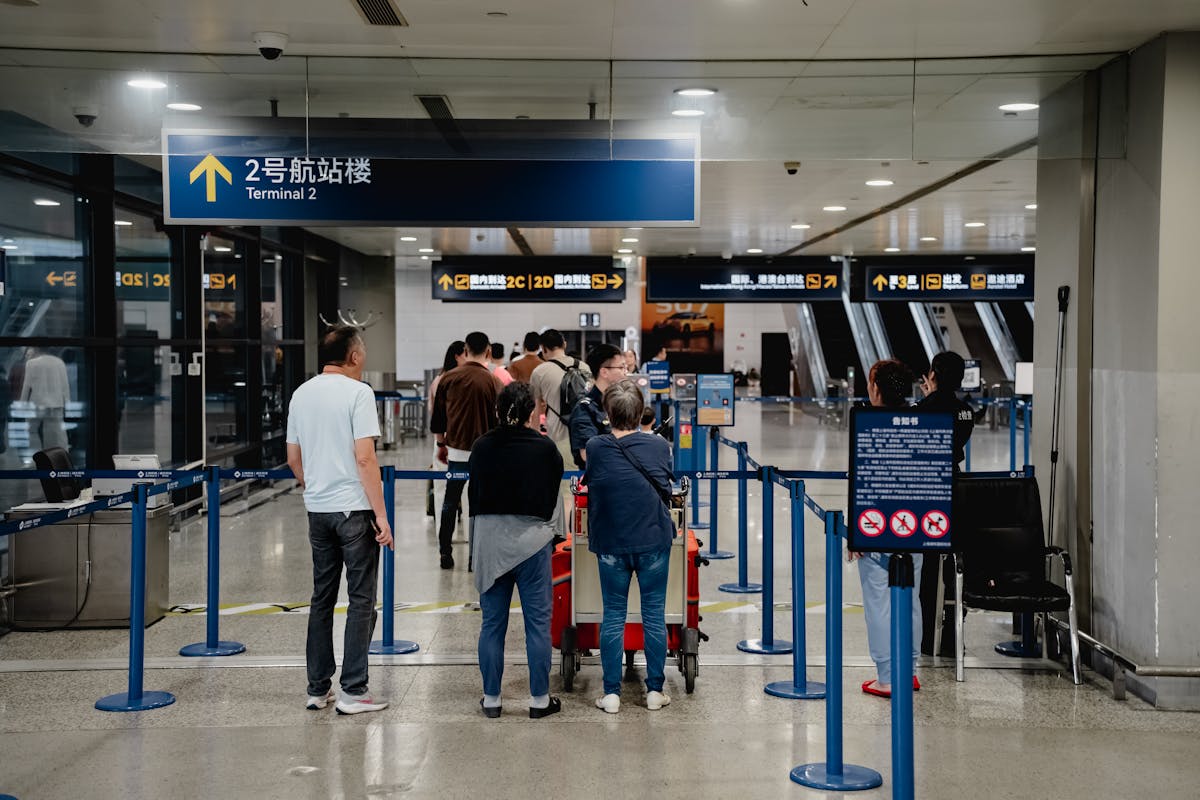Shanghai Pudong International Airport terminal exterior with passengers and signage