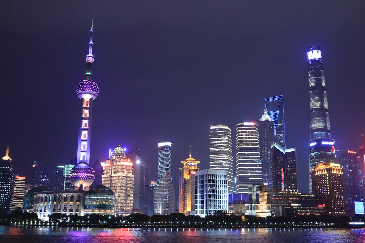 The Pudong towers of Shanghai illuminated at night across the Huangpu River