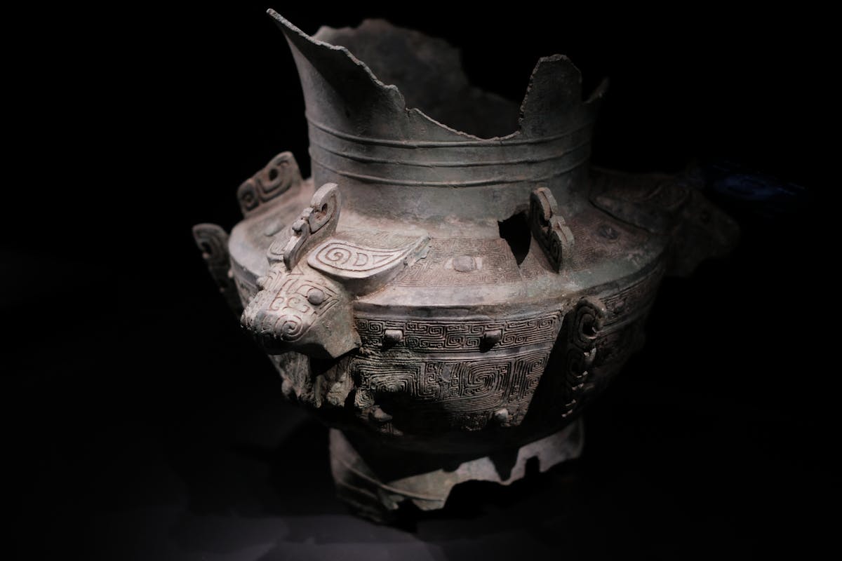 A Western Zhou bronze ritual ding vessel with three legs and inscribed interior