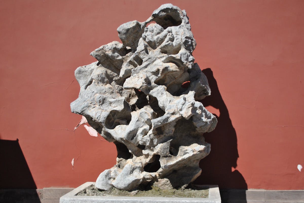 The Exquisite Jade Rock standing in a courtyard pool at Yu Garden